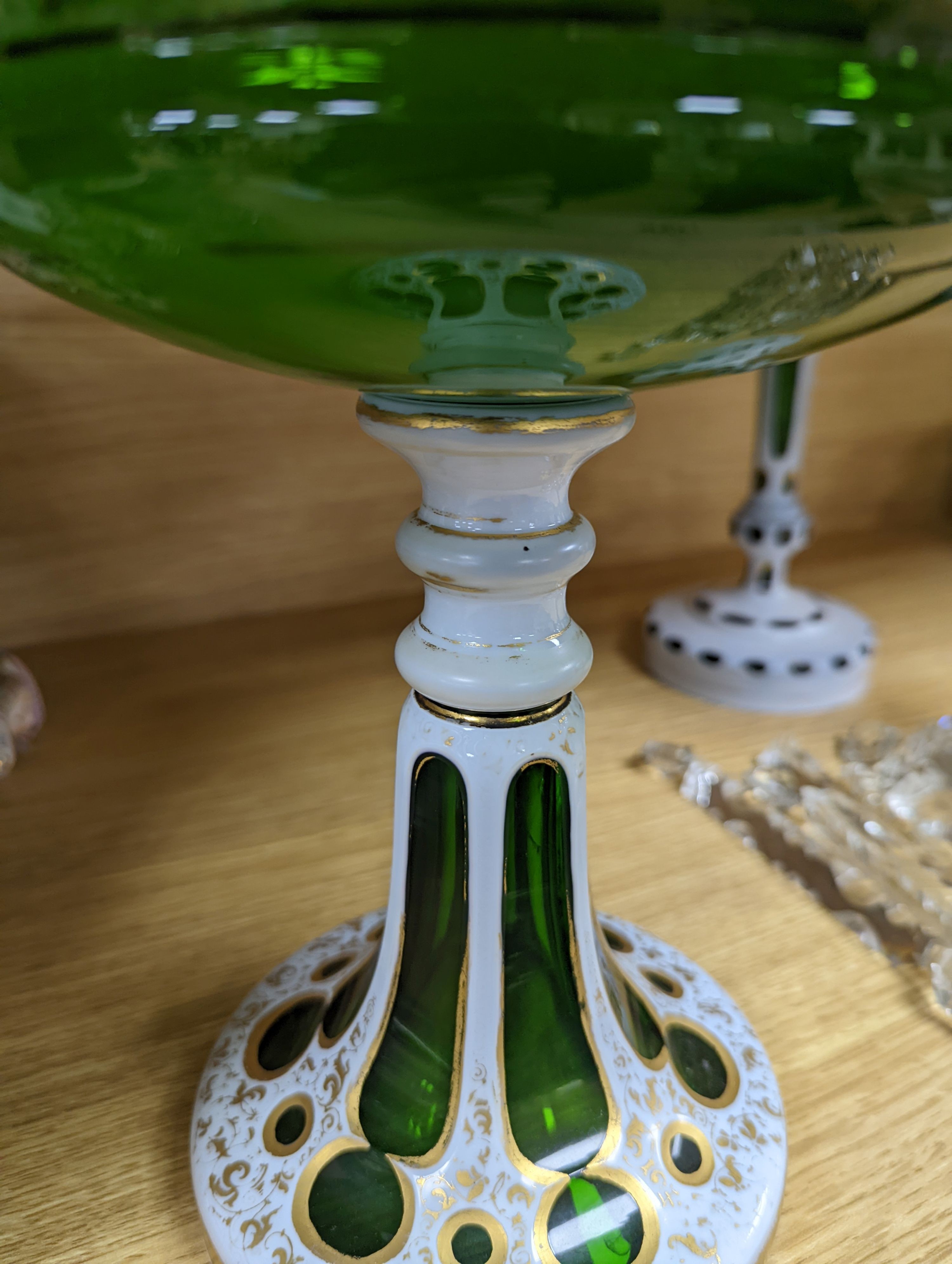 A 19th century overlaid green glass comport, 24cm high, and a similar table lustre